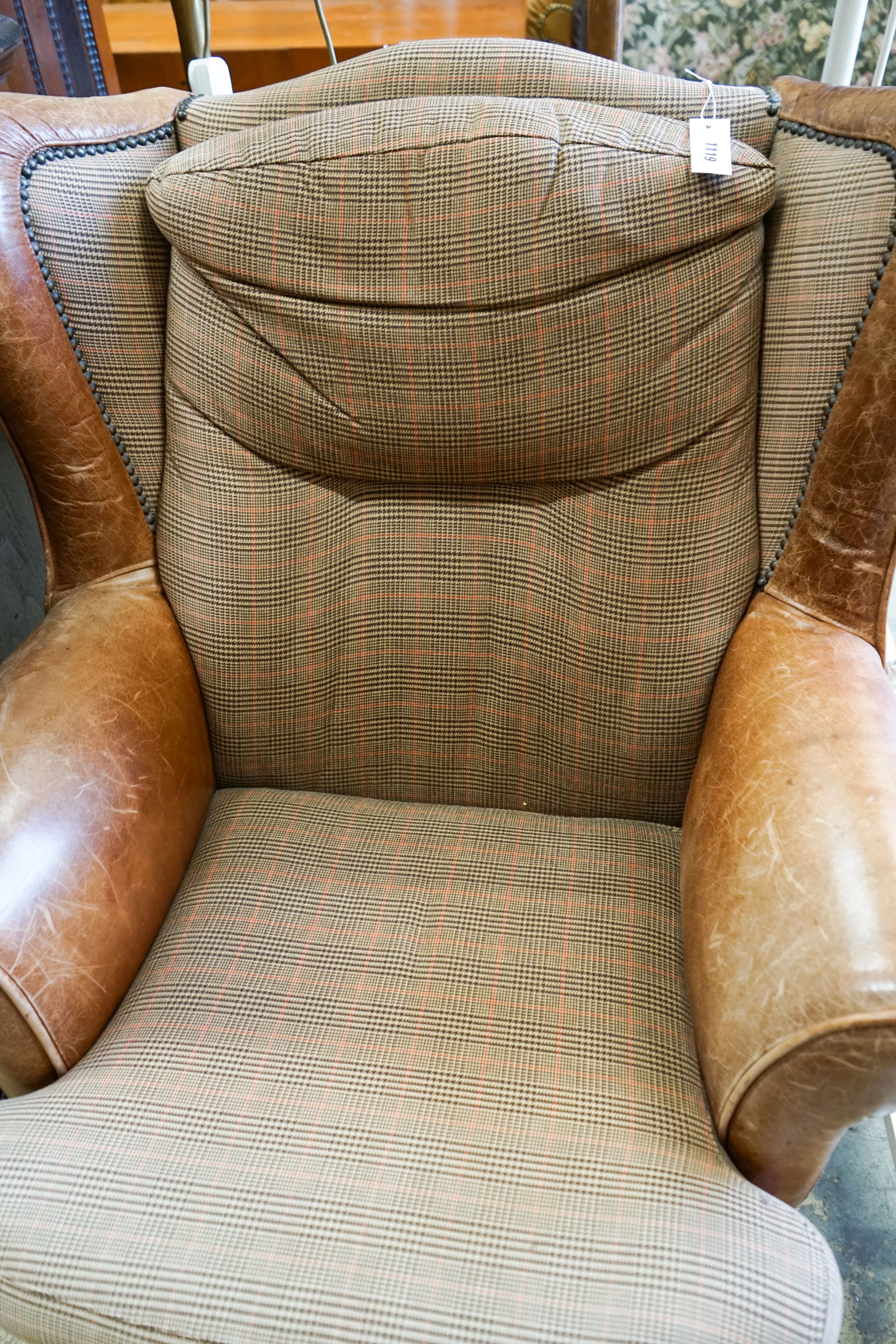 A Victorian style tweed and tan leather wing armchair, width 80cm, depth 84cm, height 98cm